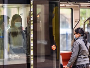 Passengers on a CTrain wear masks on Friday, July 17, 2020.