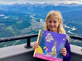 Writer's daughter at the top of the Jasper Gondola with the inspiration for her family's travels around Alberta this summer. Courtesy, Curt Woodhall