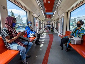 Passengers wear masks on a CTrain on Wednesday, July 22, 2020.