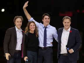 Prime Minister Justin Trudeau and his wife, Sophie, are flanked by We Day co-founders, Craig Kielburger, left, and his brother Marc, right, in front of a crowd of 16,000 people during the We Day event at the Canadian Tire Centre in Ottawa Nov. 10, 2015.