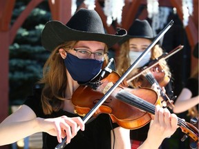 Calgary Fiddlers entertain residents for a virtual broadcast Stampede themed show at Amica Aspen Woods in southwest Calgary on Saturday, July 11, 2020. The residence has hosted a number of patio type parties for residents over the past months due to COVID restrictons.