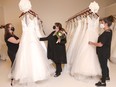 Stylists Kora-Leigh Walsh, left, and Brittney Powell, right join Leslie Durand among wedding dresses at Durand Bridal. While all eyes at a wedding are on what the bride is wearing, the mother of the bride also wants to look her part. Jim Wells/Postmedia