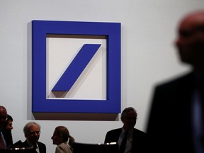 FILE PHOTO: Employees of Deutsche Bank gather ahead of the bank’s annual shareholder meeting in Frankfurt, Germany, May 23, 2019.