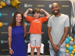 (L-R) Cheryl Bernard, Olympic Medal curler and CEO of Canada's Sports Hall of Fame, little brother Edwin and Big Brother Nicholas Cambridge following the line-up annoucement of the Big Brothers and Big Sisters All-Stars for Kids in Calgary on Tuesday, July 28, 2020. A wide range of local athletes, celebrities and influencers have stepped up to support Big Brothers Big Sisters of Calgary and Area (BBBS) with its fifth annual fundraising and awareness campaign.