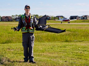 Chris Healy, owner of In-Flight Data, holds two types of the company's drones at the Okotoks Air Ranch airport on Sunday, July 19, 2020. In-Flight Data recently received a one-year certificate from Transport Canada to operate drones beyond visual line of sight (BVLOS) for the purposes of public safety.