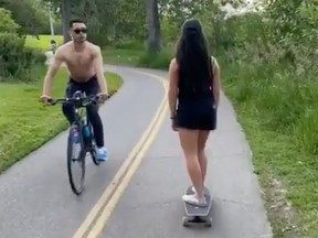 A cyclist, identified as Justin Williams by the University of Calgary, is seen riding his bicycle from the opposite direction and spitting on Lau before yelling a racial slur in this Instagram screengrab.