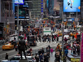 Pedestrians walk through Times Square in New York in 2018.