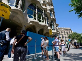 Visitors queue outside Spanish architect Antonio Gaudi's Casa Batllo on July 1, 2020 in Barcelona, on the first day it reopens to the public.