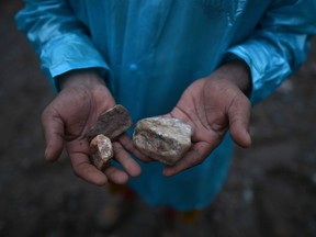 A miners shows jade at a jade mines near Hpakant in Kachin state on July 4, 2020. - Dozens of jade miners have been buried in a mass grave after a landslide in northern Myanmar killed over 170, most of them migrant workers seeking their fortune in treacherous open-cast mines near the China border.