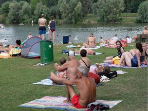 Bathers enjoy the warm and sunny weather at the Aileswasensee lake in Neckartailfingen, southern Germany, on July 25, 2020, amid the new coronavirus pandemic. (Photo by THOMAS KIENZLE / AFP)