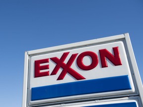 (FILES) In this file photo taken on January 5, 2016 An Exxon gas station is seen in Woodbridge, Virginia. - Exxon Mobil reported a second-quarter loss July 31, 2020, joining other petroleum giants in suffering the hit from lower oil prices due to crashing demand amid the coronavirus pandemic. (Photo by Saul LOEB / AFP)