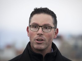 Alberta Minister of Justice and Solicitor General Doug Schweitzer makes a statement at a news conference in Calgary on December 31, 2019. Alberta's ethics commissioner says Justice Minister Doug Schweitzer did not break ethics rules when he hired Steve Allan to run the public inquiry into whether foreign money is bankrolling anti-oil protests in Canada.