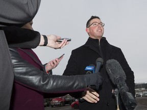 Alberta Minister of Justice and Solicitor General Doug Schweitzer makes a statement at a news conference about the federal carbon tax in Calgary, Tuesday, Dec. 31, 2019. The RCMP says it will add 76 additional Mounties to Alberta this year, many of whom will serve as frontline police in rural detachments outside of major municipalities.