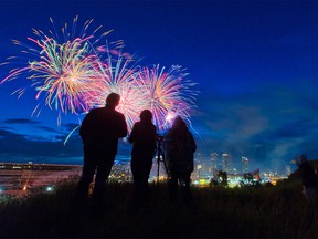 An extended fireworks display lights up the sky above Calgary and an empty Calgary Stampede grandstand and grounds on  Friday, July 3, 2020.