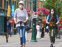 E-scooter riders wear masks as they cruise along Stephen Avenue in Calgary on Wednesday, July 15, 2020.