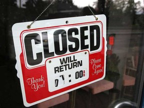 A Closed sign is taped to the door of a salon in Kensington.