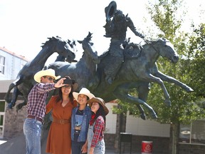 The Yehara family, from left, Toshi, Karen, Cohen and Kaya, take a selfie at Stampede Park in Calgary on Sunday. The Calgary family was missing the Stampede spirit and decided to get dressed up and visit the Stampede Grounds on what would have been the last Sunday of Stampede, which was cancelled due to the COVID-19 pandemic.