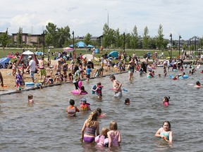 Beachgoers and water enthusiasts are shown on a stretch of beach in Chestermere, AB east of Calgary on Thursday, July 16, 2020.
