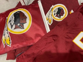 Washington Redskins football shirts and a team flag on sale at a sporting goods store in Bailey's Crossroads, Virginia, U.S., June 24, 2020.
