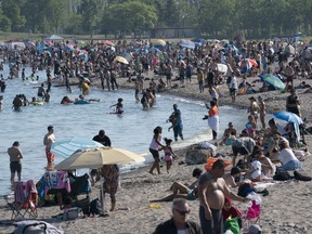 Scientists are warning that more young people are being infected with COVID-19, creating the potential for a severe outbreak. Thousands of people spend time on the beach by Lake Ontario in Toronto on Saturday June 20, 2020.