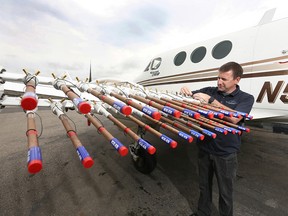 Pilot Brian Kindrat checks equipment on a plane used to cloud seed at Springbank Airport, west of Calgary on Friday, July 24, 2020.