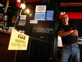 Landlord Johnny McFadden, 61, poses for a photo at the bar area of The Star Inn, where an electric fence has been installed at the bar area to ensure customers are socially distanced from staff while ordering drinks, following the outbreak of the coronavirus disease (COVID-19), in in St Just, Cornwall, Britain July 14, 2020.