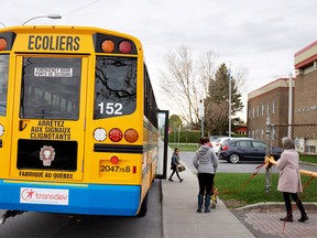 FILE PHOTO: A school bus arrives carrying one student as schools outside the greater Montreal region begin to reopen their doors amid the coronavirus disease (COVID-19) outbreak, in Saint-Jean-sur-Richelieu, Quebec, Canada May 11, 2020.