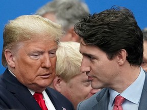 U.S. President Donald Trump talks with Canada's Prime Minister Justin Trudeau during a North Atlantic Treaty Organization Plenary Session at the NATO summit.