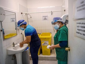 A nurse washes her hands at the end of her shift at the Barros Luco Hospital in Santiago, Chile, on July 22, 2020.