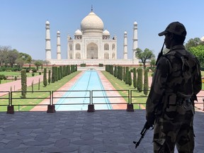 A member of Central Industrial Security Force (CISF) personnel stands guard inside the empty premises of the historic Taj Mahal during a 21-day nationwide lockdown to slow the spread of COVID-19, in Agra, India, April 2, 2020.