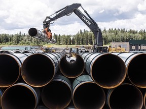 Pipe for the Trans Mountain pipeline is unloaded in Edson on June 18, 2019.