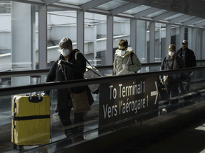 People leave the terminal after arriving at Pearson International Airport in Toronto in March.