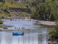 Calgarians cool off by the Elbow River in Sandy Beach Park as a heat warning's in effect on Monday, August 17, 2020.
