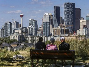 People spend late summer morning in Tom Campbell's Hill Natural Park with the view of downtown Calgary in the background on Tuesday, August 25, 2020.