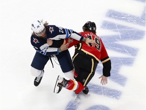 EDMONTON, ALBERTA - AUGUST 01: Blake Wheeler #26 of the Winnipeg Jets and Matthew Tkachuk #19 of the Calgary Flames fight in Game One of the Western Conference Qualification Round prior to the 2020 NHL Stanley Cup Playoffs at Rogers Place on August 01, 2020 in Edmonton, Alberta. (Photo by Jeff Vinnick/Getty Images)