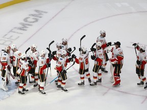 The Calgary Flames celebrate their 3-0 victory obrt the Winnipeg Jets to win Game 4 of the Western Conference Qualification Round prior to the 2020 NHL Stanley Cup Playoffs at Rogers Place on August 6, 2020, in Edmonton, Alberta.