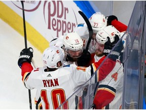 EDMONTON, ALBERTA - AUGUST 11: Rasmus Andersson #4 of the Calgary Flames (R) celebrates his goal against the Dallas Stars at 16:01 of the second period in Game One of the Western Conference First Round during the 2020 NHL Stanley Cup Playoffs at Rogers Place on August 11, 2020 in Edmonton, Alberta, Canada.