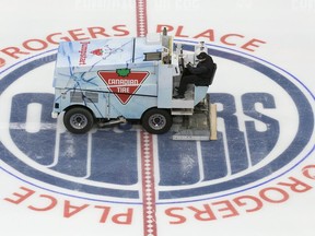 A zamboni driver wearing a face mask floods the ice during the first day of the Edmonton Oilers training camp for the 2019-20 NHL return to play venture at Rogers Place on Monday, July 13, 2020.