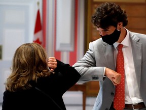 Chrystia Freeland, deputy prime minister, elbow bumps Prime Minister Justin Trudeau after she is sworn in as finance minister at Rideau Hall in Ottawa, August 18, 2020.