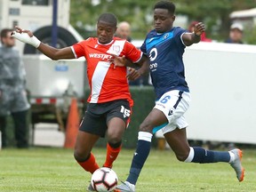 Cavalry FC’s Elijah Adekugbe (left) battles Edmonton FC’s Edem Mortotski during Canadian Premier League action at ATCO Field at Spruce Meadows in Calgary on Aug. 16, 2019. The Alberta rivals, along with other CPL teams, are travelling together to Charlottetown, P.E.I., for the The Island Games tournament. Jim Wells/Postmedia
