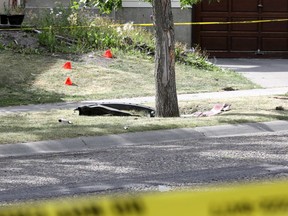Calgary police hold the scene of a shooting that left two men dead Friday evening on Sandarac Road N.W. in Calgary on Saturday, August 29, 2020.