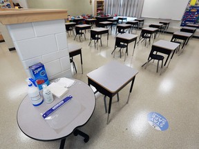 Masks and sanitizer are laid out in a classroom in southeast Calgary on Aug. 25, 2020.