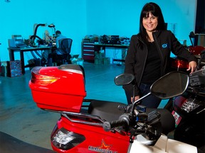 Sue Ozdemir, CEO of Exro Technologies Inc., stands with electric motor bikes in the company's Calgary facility on Wednesday, August 26, 2020. Exro Technologies has designed technology to improve the performance, efficiency, and longevity of batteries, electric motors and generators.