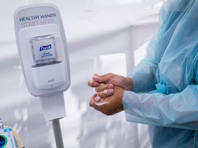 A public health worker uses hand sanitizer at a Covid-19 testing site in Martinez, California, U.S., on Tuesday, Aug. 4, 2020.