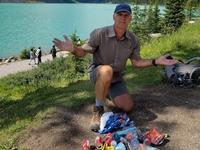 Lake Louise guide Mike Vincent kneels in front of litter at Lake Agnes on Aug. 3, 2020.