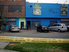 Police officers are seen outside a nightclub after it was raided for hosting a party in violation of the coronavirus disease (COVID-19) restrictions, in Lima, Peru, August 23, 2020.