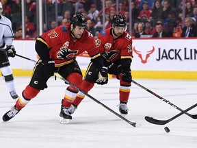 Dec 7, 2019; Calgary, Alberta, CAN; Calgary Flames' Milan Lucic (17) and Dillon Dube (29) chase after the puck in the third period against the Los Angeles Kings at Scotiabank Saddledome.