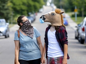 Michelle Tarr and son Freedom walk with their masks on in N.E. Calgary on Tuesday, August 18, 2020.