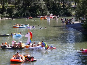 Calgarians beat the heat by hanging out on the Elbow River at Stanley Park on Sunday, August 16, 2020.