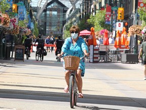 Nicole Gagnon is seen enjoying a bicycle ride down Stephen Ave. SW on a warm afternoon. Monday, August 10, 2020.